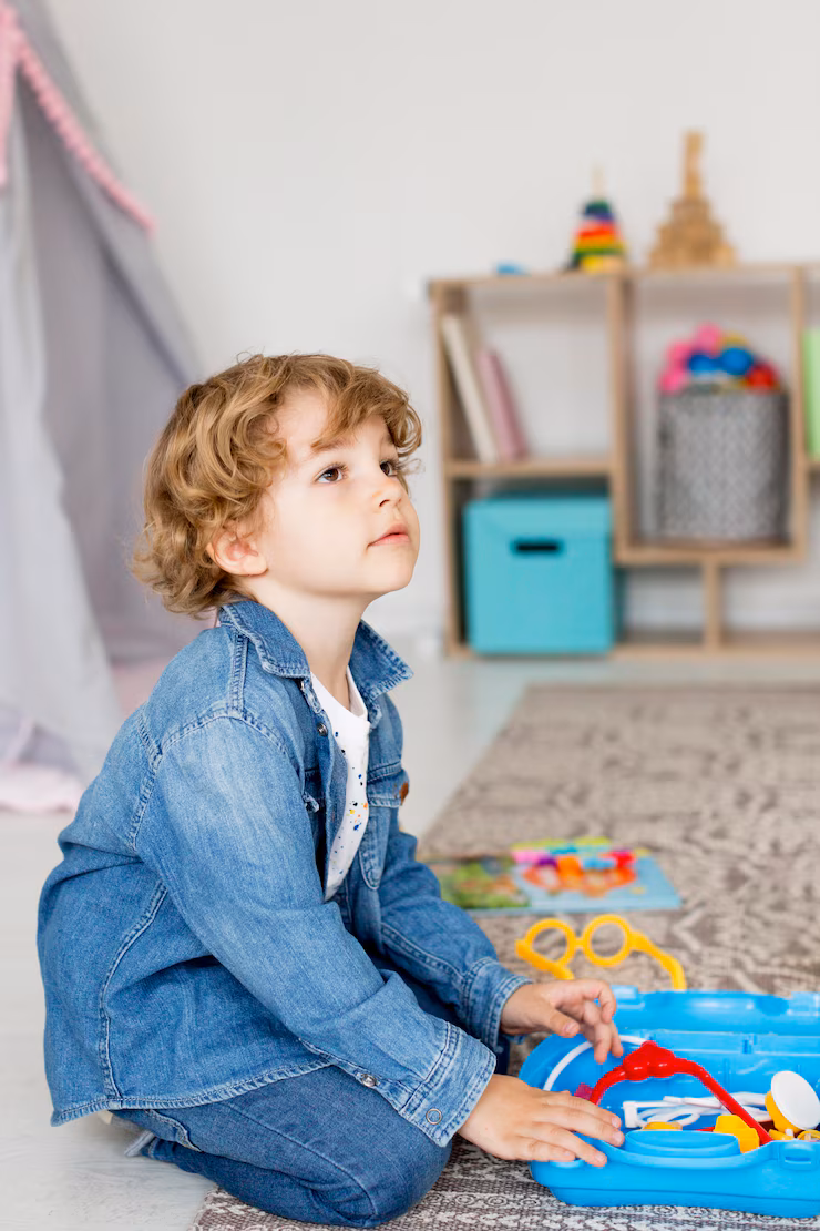 side-view-boy-playing-with-toys-home_23-2148572950